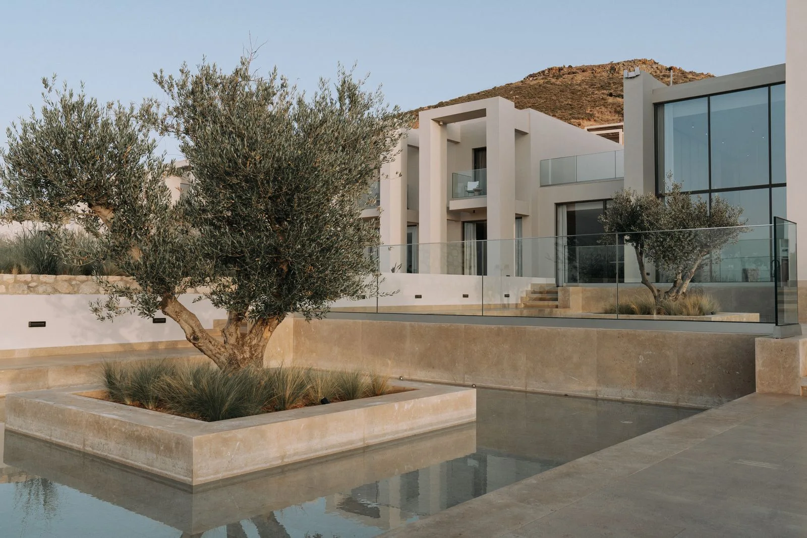 Contemporary home combining glass, stone and generous window openings
